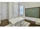 Bright playroom with a chalkboard, table and chairs, light walls, and beautiful dark wood floors at 1489 Red Tide Rd, Mount Pleasant, SC 29466
