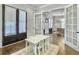 Bright playroom with French doors, white table and chairs, light walls, and beautiful dark wood floors at 1489 Red Tide Rd, Mount Pleasant, SC 29466