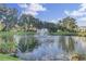 Scenic pond featuring a fountain, enhanced by lush landscaping and mature trees in a serene setting at 1489 Red Tide Rd, Mount Pleasant, SC 29466