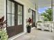 Charming front porch with a swing, complemented by elegant double doors and decorative plants at 1489 Red Tide Rd, Mount Pleasant, SC 29466