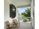 Exterior porch with wicker chairs and pillows, offering a cozy spot to enjoy the outdoor views at 1489 Red Tide Rd, Mount Pleasant, SC 29466