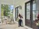 Charming porch area featuring an outdoor dining set, complemented by elegant double doors at 1489 Red Tide Rd, Mount Pleasant, SC 29466