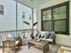 Cozy screened porch with comfortable seating and natural light at 1489 Red Tide Rd, Mount Pleasant, SC 29466