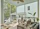 Relaxing screened porch with seating and ceiling fan at 1489 Red Tide Rd, Mount Pleasant, SC 29466