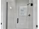 Modern shower featuring sleek glass doors, white subway tile, and dark hardware at 1489 Red Tide Rd, Mount Pleasant, SC 29466