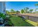 Spacious grassy backyard featuring a hammock, garden beds and a dark picket fence at 1515 Pogonia St # 2, Mount Pleasant, SC 29466