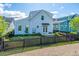 Home's backyard featuring a black picket fence, a hammock, and lush landscaping at 1515 Pogonia St # 2, Mount Pleasant, SC 29466