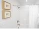Clean bathroom featuring white tiled shower with framed art on the walls at 1515 Pogonia St # 2, Mount Pleasant, SC 29466