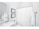Bright bathroom with white fixtures, vanity, and shower with white curtain at 1515 Pogonia St # 2, Mount Pleasant, SC 29466