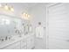 Bright bathroom featuring a double vanity with white marble countertop and white cabinets at 1515 Pogonia St # 2, Mount Pleasant, SC 29466