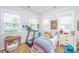 Bright bedroom features a charming bed, lots of natural light, and a treadmill for exercise at 1515 Pogonia St # 2, Mount Pleasant, SC 29466