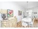 Elegant dining room with white table and chairs, complemented by stylish artwork at 1515 Pogonia St # 2, Mount Pleasant, SC 29466