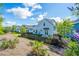 Charming light blue two-story home with black picket fence and lush landscaping at 1515 Pogonia St # 2, Mount Pleasant, SC 29466