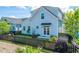 Attractive light blue house with a black picket fence and well-manicured yard at 1515 Pogonia St # 2, Mount Pleasant, SC 29466