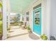 Cozy front porch featuring seating, decorative plants, and a bright blue door at 1515 Pogonia St # 2, Mount Pleasant, SC 29466