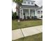 Charming home with a manicured lawn, inviting porch, and a vibrant blue front door at 1515 Pogonia St # 2, Mount Pleasant, SC 29466