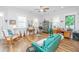 Cozy living room with a comfortable green sofa and natural light from multiple windows at 1515 Pogonia St # 2, Mount Pleasant, SC 29466