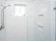 Modern shower with white marble tile, built-in shelves, and a sleek shower head at 1515 Pogonia St # 2, Mount Pleasant, SC 29466