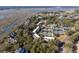 Breathtaking aerial view of a community surrounded by waterways and tennis courts in a beautiful setting at 1605 Live Oak Park, Seabrook Island, SC 29455