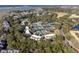 Beautiful aerial view of a property with mature trees, a lake, and tennis courts in a tranquil setting at 1605 Live Oak Park, Seabrook Island, SC 29455