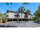 Beige condo building on stilts with parking underneath and mature palm trees at 1605 Live Oak Park, Seabrook Island, SC 29455