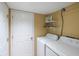 Bright laundry area showcasing a modern washer and dryer set with convenient shelving for storage at 1605 Live Oak Park, Seabrook Island, SC 29455