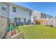 Fenced backyard offers a patio seating area, lush lawn, and ample space for outdoor activities at 163 Spencer Cir, Summerville, SC 29485