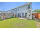 Inviting backyard showcases a well-maintained lawn, patio seating, and a secure privacy fence at 163 Spencer Cir, Summerville, SC 29485