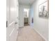 Hallway leading to bathroom with dual sink, showcasing neutral tones, carpet, and natural light at 163 Spencer Cir, Summerville, SC 29485