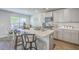 Well-lit kitchen with island, stainless steel appliances, and open access to the adjacent dining area at 163 Spencer Cir, Summerville, SC 29485