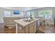 Contemporary kitchen island with sink and dishwasher, open to living room, dining area, and outdoor views at 163 Spencer Cir, Summerville, SC 29485