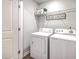 Well-lit laundry area with appliances and shelving for organized storage and convenience at 163 Spencer Cir, Summerville, SC 29485