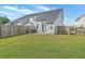 Large fenced backyard with green grass, patio with furniture, and a grill at 184 Kirkland St, Goose Creek, SC 29445