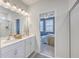 Bright bathroom featuring dual sinks, white cabinetry, and an adjoining bedroom at 184 Kirkland St, Goose Creek, SC 29445
