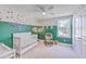 Bright bedroom features an accent wall, ceiling fan, and cozy rocking chair at 184 Kirkland St, Goose Creek, SC 29445