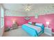 Playful pink bedroom features an accent wall, ceiling fan, and cozy turquoise bedding at 184 Kirkland St, Goose Creek, SC 29445