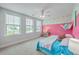 Bright bedroom features an accent wall, ceiling fan, and large windows at 184 Kirkland St, Goose Creek, SC 29445