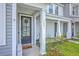 Close-up of the front door with wreath and welcome mat, complemented by well-maintained landscaping at 184 Kirkland St, Goose Creek, SC 29445