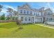 Charming two-story home features a well-manicured lawn, gray siding and plenty of windows for natural light at 184 Kirkland St, Goose Creek, SC 29445