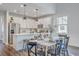 Bright kitchen with white cabinets and stainless appliances adjoins a dining area and table at 184 Kirkland St, Goose Creek, SC 29445