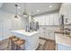 Modern kitchen features white cabinetry, stainless steel appliances, and center island with seating at 184 Kirkland St, Goose Creek, SC 29445
