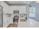 Well-lit kitchen features stainless steel appliances, white cabinetry, and marble countertops at 184 Kirkland St, Goose Creek, SC 29445