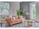 Cozy living room featuring a comfortable tan leather sofa, natural light, and a neutral-toned rug at 184 Kirkland St, Goose Creek, SC 29445