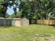 Backyard view highlighting a metal storage shed with a new wooden fence at 2 Clarksville Ln, Goose Creek, SC 29445