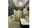 Olive-toned bathroom features a unique crystal chandelier, standing shower, and black vanity with marble countertop at 2 Clarksville Ln, Goose Creek, SC 29445