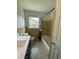 The bathroom features a sleek white vanity, a toilet, and a tub with a shower curtain, creating a clean, functional space at 2 Clarksville Ln, Goose Creek, SC 29445