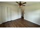 This bedroom features wood floors, a ceiling fan, and a connecting door to another part of the house at 2 Clarksville Ln, Goose Creek, SC 29445