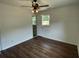 Bedroom with a ceiling fan, wood-look flooring, and a window at 2 Clarksville Ln, Goose Creek, SC 29445