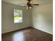Bedroom with a ceiling fan, hardwood floors, and a bright window offering neighborhood views at 2 Clarksville Ln, Goose Creek, SC 29445