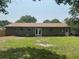 Rear exterior view showcasing the brick home with a well-maintained lawn at 2 Clarksville Ln, Goose Creek, SC 29445